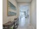 Welcoming hallway with decorative table, neutral walls, and views into the living area at 18385 W Devonshire Ave, Goodyear, AZ 85395