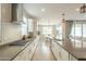 Modern kitchen with stainless steel appliances, gray countertops, white cabinets, and a large island at 18385 W Devonshire Ave, Goodyear, AZ 85395