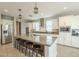 Spacious kitchen featuring a large island with barstool seating and stainless steel appliances at 18385 W Devonshire Ave, Goodyear, AZ 85395