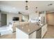 Open concept kitchen with a large island flowing into the living room at 18385 W Devonshire Ave, Goodyear, AZ 85395