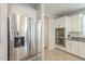 A stainless steel refrigerator stands beside white cabinets and stainless steel double ovens at 18385 W Devonshire Ave, Goodyear, AZ 85395