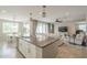 Open kitchen view to living room, featuring stainless appliances, gray countertops, and recessed lighting at 18385 W Devonshire Ave, Goodyear, AZ 85395