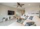 Bright living room with plush furniture, recessed lighting, and large entertainment center at 18385 W Devonshire Ave, Goodyear, AZ 85395