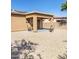Covered patio offers a cozy retreat with outdoor seating and views of the landscaped yard at 1869 E Birch St, Casa Grande, AZ 85122
