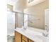 Bright bathroom featuring double sinks, large mirror, and walk-in shower at 1869 E Birch St, Casa Grande, AZ 85122