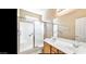 Well-lit bathroom featuring dual sinks and a shower with a glass door at 1869 E Birch St, Casa Grande, AZ 85122