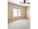 Carpeted bedroom with ceiling fan and bright window at 1869 E Birch St, Casa Grande, AZ 85122