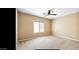 Neutral bedroom featuring ceiling fan, window, and carpet flooring at 1869 E Birch St, Casa Grande, AZ 85122