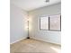 Bright bedroom featuring neutral carpet, baseboards, and large window at 1869 E Birch St, Casa Grande, AZ 85122