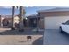 Inviting single-story home with desert landscaping, a two-car garage, and clear blue skies at 1869 E Birch St, Casa Grande, AZ 85122