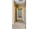 Hallway with neutral carpet, baseboards, and access to other rooms at 1869 E Birch St, Casa Grande, AZ 85122