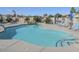 Community pool with lounge chairs, rock feature, and landscaping for a relaxing oasis at 1869 E Birch St, Casa Grande, AZ 85122