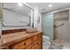 Stylish bathroom with a vessel sink, wood vanity, and a tiled shower, creating a modern and functional space at 1880 E Morten Ave # 124, Phoenix, AZ 85020