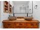 Stylish bathroom features double stone vessel sinks on a wood vanity and modern fixtures at 1880 E Morten Ave # 124, Phoenix, AZ 85020