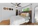 Cozy bedroom featuring wood floors, a modern ceiling fan, and a view of natural light, creating an inviting space at 1880 E Morten Ave # 124, Phoenix, AZ 85020