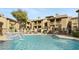 Inviting community pool area with comfortable lounge chairs, landscaping, and an attractive waterfall feature at 1880 E Morten Ave # 124, Phoenix, AZ 85020