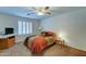 Comfortable bedroom with neutral carpeting, ceiling fan, and window with plantation shutters at 2101 S Meridian Rd # 190, Apache Junction, AZ 85120