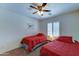 Cozy bedroom with matching twin beds, ceiling fan, and window with plantation shutters at 2101 S Meridian Rd # 190, Apache Junction, AZ 85120