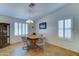 Charming dining area features a wooden table, seating for four, and plantation shutters for a bright, airy feel at 2101 S Meridian Rd # 190, Apache Junction, AZ 85120