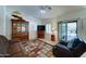 Open-concept living room with a decorative rug, ceiling fan, sliding doors to the exterior, and a hutch at 2101 S Meridian Rd # 190, Apache Junction, AZ 85120