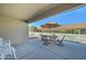 Covered patio with a dining set under an umbrella, perfect for outdoor relaxation and entertaining at 2101 S Meridian Rd # 190, Apache Junction, AZ 85120