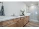 Beautiful bathroom featuring double vanities, modern finishes, and a glass-enclosed shower at 2121 W Sonoran Desert Dr # 93, Phoenix, AZ 85085