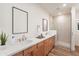 Modern bathroom featuring a double vanity, a glass-enclosed shower, and sleek fixtures at 2121 W Sonoran Desert Dr # 93, Phoenix, AZ 85085