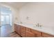 Bright bathroom with dual sinks, wood cabinets, and modern fixtures on a light countertop at 2121 W Sonoran Desert Dr # 93, Phoenix, AZ 85085