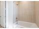 Clean bathroom with a white bathtub, tiled walls, and a modern shower head at 2121 W Sonoran Desert Dr # 93, Phoenix, AZ 85085