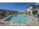 Resort-style community pool with ample lounge seating and modern building architecture at 2121 W Sonoran Desert Dr # 93, Phoenix, AZ 85085