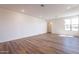 Spacious living room featuring hardwood flooring and ample natural light from a large window creates a bright and inviting atmosphere at 2121 W Sonoran Desert Dr # 93, Phoenix, AZ 85085