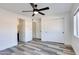 Bedroom with new flooring, modern ceiling fan, a closet and view of a bathroom at 2217 E Sheridan St, Phoenix, AZ 85006