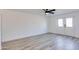 Bright bedroom featuring wood-look floors, a ceiling fan, and a large window for ample natural light at 2217 E Sheridan St, Phoenix, AZ 85006