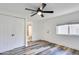 Well-lit bedroom with closet, ceiling fan, and views to an adjacent bathroom and backyard at 2217 E Sheridan St, Phoenix, AZ 85006