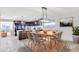 Contemporary dining area with open floor plan, stylish chairs, modern light fixture, and kitchen access at 2217 E Sheridan St, Phoenix, AZ 85006
