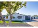 Charming exterior with modern design elements, including a sleek garage door and a well-manicured lawn at 2217 E Sheridan St, Phoenix, AZ 85006