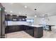 Spacious kitchen featuring dark cabinetry, stainless steel appliances, and a quartz countertop island at 2217 E Sheridan St, Phoenix, AZ 85006