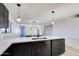 Close up of quartz countertops and dark kitchen cabinets, featuring a sink with a modern faucet at 2217 E Sheridan St, Phoenix, AZ 85006