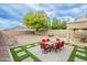 Expansive backyard features desert landscaping, a covered patio, a dining set, and a playground at 25622 N Singbush Loop, Phoenix, AZ 85083