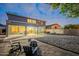 Nighttime view of the backyard with patio, landscaping, and entertainment area at 25622 N Singbush Loop, Phoenix, AZ 85083