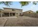 Spacious backyard featuring a seating area with a red table and chairs, and ample space for activities at 25622 N Singbush Loop, Phoenix, AZ 85083