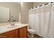 Bathroom with wood vanity, a single sink, a mirror, and a shower with a white curtain for a serene retreat at 25622 N Singbush Loop, Phoenix, AZ 85083