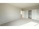 Neutral bedroom with closet and doorway with neutral walls and carpet at 25622 N Singbush Loop, Phoenix, AZ 85083