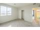 Bright bedroom featuring carpet, a window, a closet, and an en-suite bathroom at 25622 N Singbush Loop, Phoenix, AZ 85083