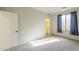 Well-lit bedroom featuring carpet, closet, and a window with decorative blue curtains at 25622 N Singbush Loop, Phoenix, AZ 85083