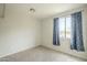 Cozy bedroom with carpet, window with star-patterned curtains, and neutral paint at 25622 N Singbush Loop, Phoenix, AZ 85083