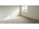 Bedroom featuring a window, neutral walls and carpet, illuminated by sunlight at 25622 N Singbush Loop, Phoenix, AZ 85083