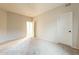 Bright bedroom showcasing neutral walls, plush carpet, and two entryways that offer comfort and space at 25622 N Singbush Loop, Phoenix, AZ 85083