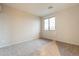 Bright bedroom featuring neutral walls, plush carpet, and a window offering plenty of natural light and a serene ambiance at 25622 N Singbush Loop, Phoenix, AZ 85083