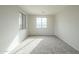 Bedroom with two windows and neutral carpet, with neutral walls at 25622 N Singbush Loop, Phoenix, AZ 85083